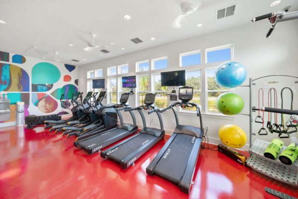 State-of-the-art fitness center with three treadmills, three ellipticals, three exercise balls, two foam rollers, and many resistance bands.